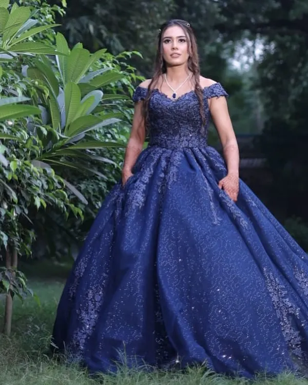 A full-length shot of my client ready for her engagement photoshoot in a stunning blue ball gown. The makeup is soft and romantic, with an emphasis on glowing skin and defined eyes, creating a look that is both elegant and memorable.
