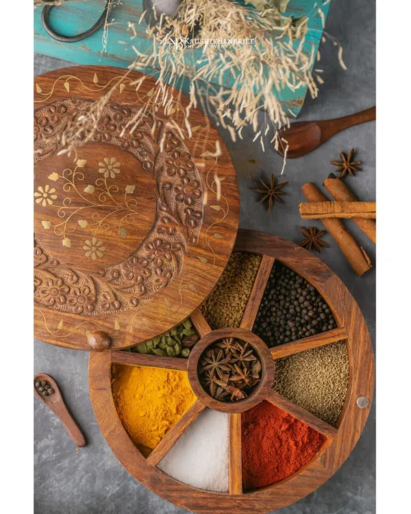 A beautifully crafted wooden spice box, shot for a product brand. The focus here is on the rich colors and textures of the spices, creating an image that speaks to quality and authenticity.