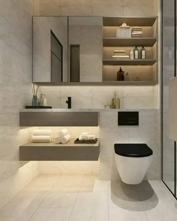 A modern bathroom design featuring light-colored tiles, a floating wooden vanity with shelf lighting, and a wall-mounted toilet for a clean, spacious look.
