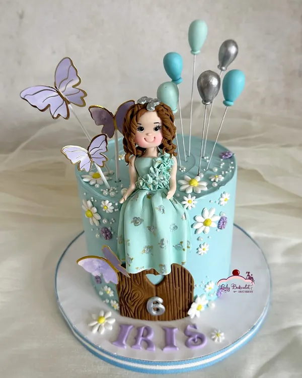 A beautiful cake for Iris turning 6! The dress on the hand-sculpted sugar figurine was designed to match her actual birthday dress.