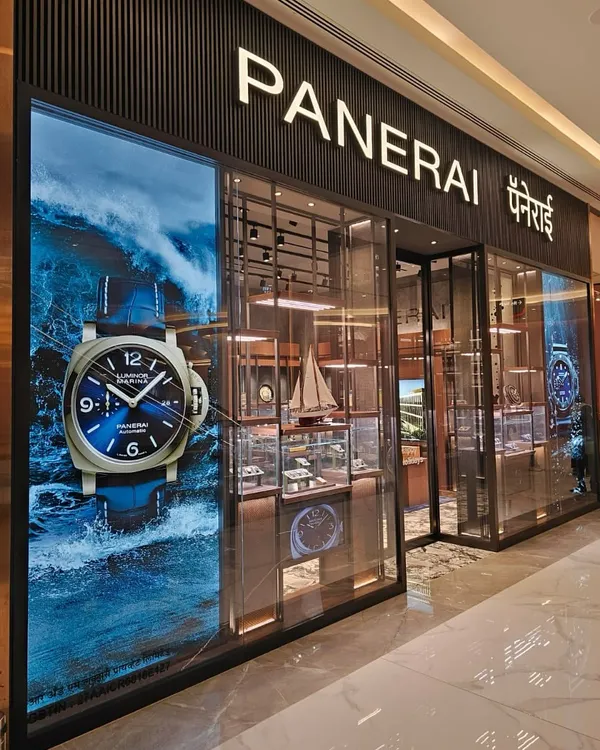 The facade of the Panerai boutique at Jio World Plaza, Mumbai, makes a bold statement, reflecting the brand's deep connection to the sea. A large, dynamic visual of the Luminor watch is paired with a transparent entrance, inviting patrons to step into the world of Italian naval heritage and horological precision.
