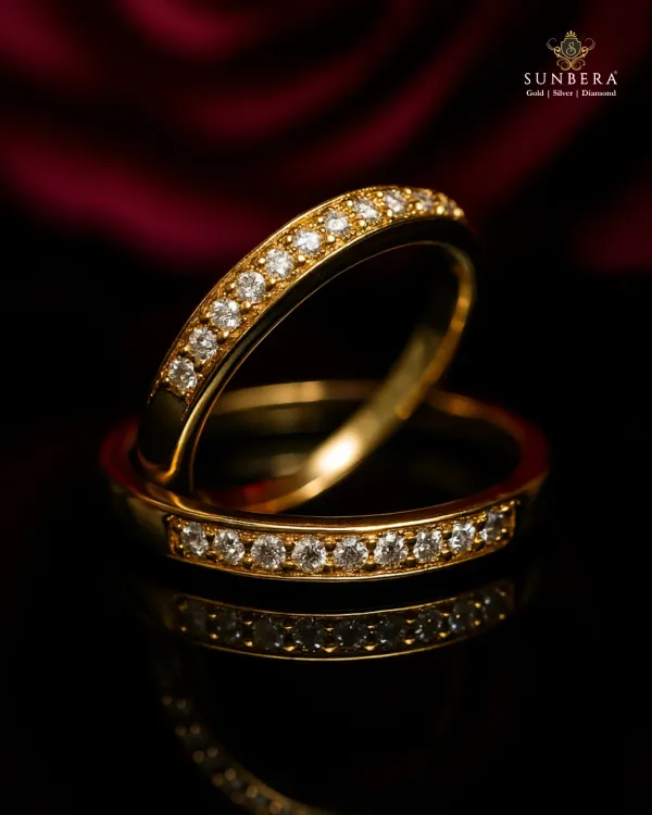 These elegant couple rings feature a band of channel-set diamonds in polished gold. The timeless design is perfect for engagements, anniversaries, or simply as a beautiful symbol of your commitment.
