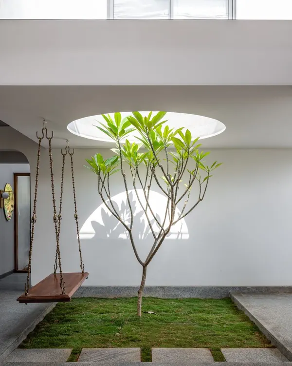 This central courtyard in the SAMAM House, featuring a skylight and a traditional swing, embodies our core principle of integrating nature and light into the heart of the home. It acts as a green lung, creating a tranquil and visually connected living experience.