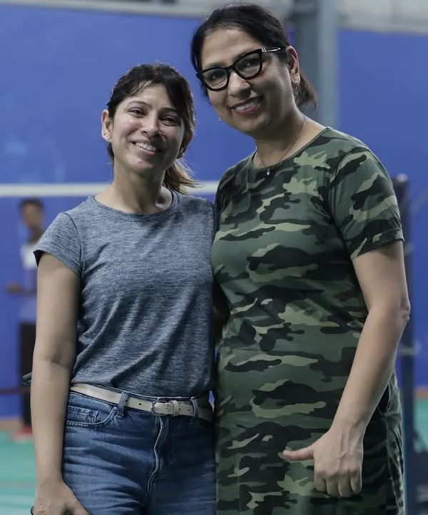 Two colleagues enjoying the event. The badminton court is a great equalizer, a place where team members can connect and build friendships outside of meetings and deadlines.
