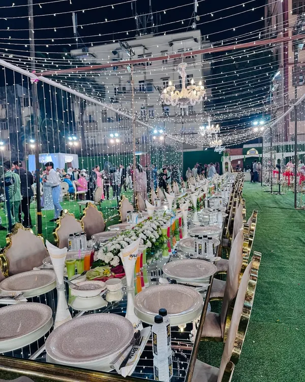This is the standard I set for a grand celebration. A beautifully arranged sit-down dinner with mirrored tables reflecting the fairy lights, elegant floral centerpieces, and impeccable place settings, all ready for your guests to arrive.