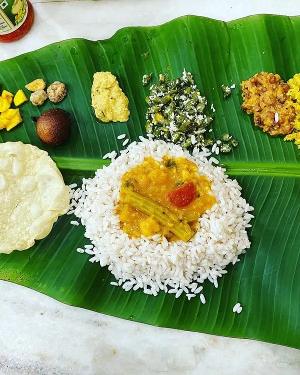 A full Kerala Sadya served on a fresh banana leaf. This is the heart of my cooking, a traditional vegetarian feast with rice, sambar, pickles, pappadam, and various vegetable dishes, just like the ones I grew up with.