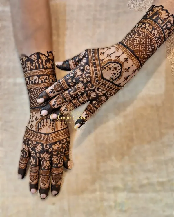 A perfect example of a back-hand sider design. This style is popular with guests as it leaves the palm free while showcasing beautiful art, featuring floral patterns and elephant motifs on the wrist.