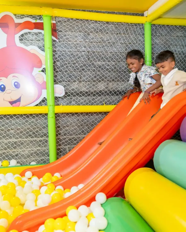 Two friends sliding into a sea of fun. Our multi-lane slide encourages parallel play and helps children learn to take turns while enjoying the thrill of the ride.