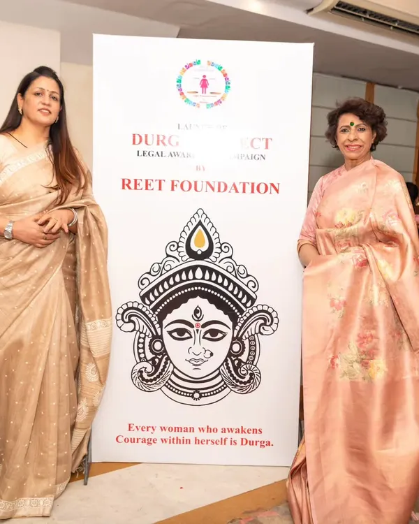 Standing beside the banner for Project 'Durga', an initiative by my Reet Foundation. The tagline says it all: "Every woman who awakens courage within herself is Durga."