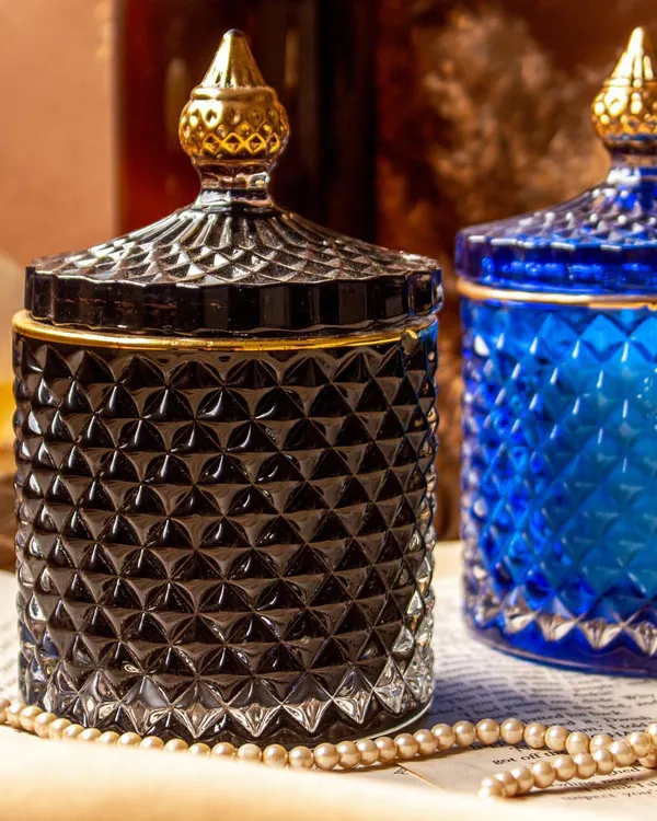 Introducing my golden line crystal jar soy candles, designed to add a touch of luxury to your home. The intricate design and rich colors, like this deep black and royal blue, make them a stunning decor piece.