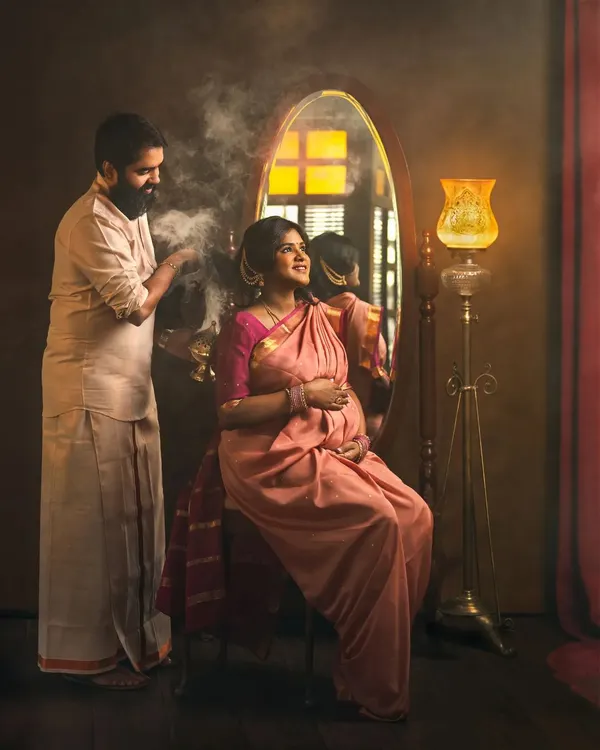 This maternity portrait is a full story in one frame. The traditional attire, the vintage props, and the tender interaction between the couple create a unique and culturally rich scene. The use of smoke adds a touch of ritual and magic to this moment of anticipation.