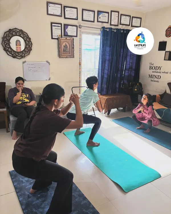 A group of young clients practice a squat variation, building foundational strength and coordination in a fun, supportive environment.