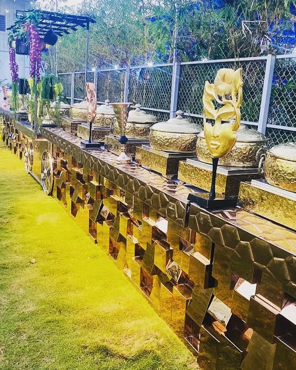 This is an example of my fully decorated, premium buffet line for an outdoor corporate event. The golden, textured counter and elegant serveware create a royal touch that elevates the entire dining experience.