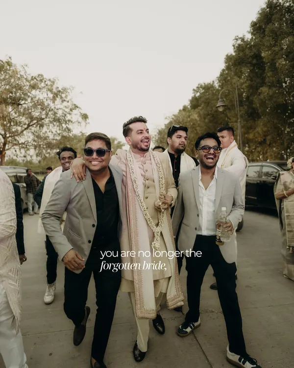 We believe grooms deserve the spotlight too. This shot captures the groom and his entourage heading to the ceremony, with the groom looking sharp and confident in a custom-styled sherwani.