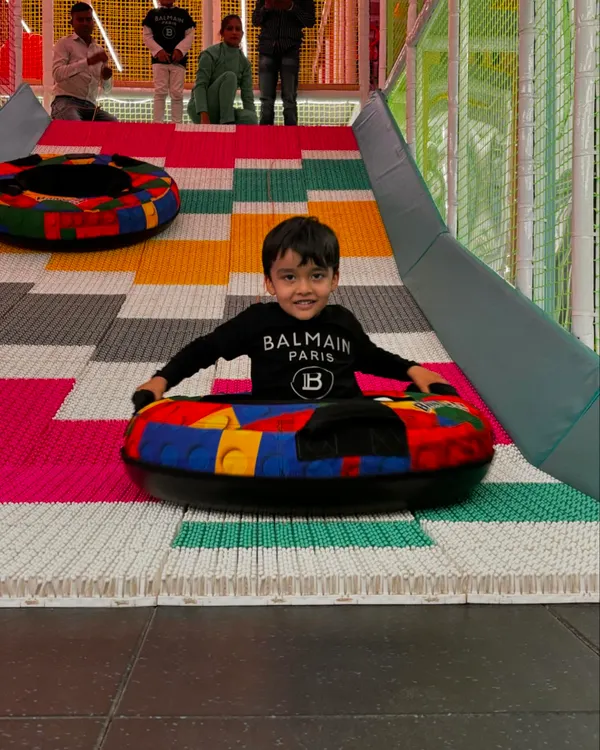 A perfect action shot of a child enjoying our colorful donut slide. This is the kind of pure, simple joy we create every day.