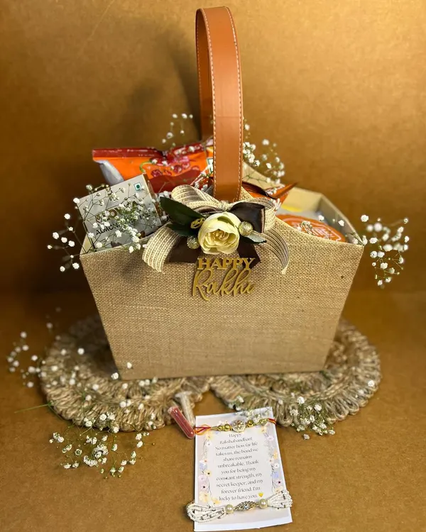 Kickstart your Rakhi celebrations with a hamper that’s full of love. This rustic jute basket is personalized with a "Happy Rakhi" tag and filled with snacks and treats, perfect for your brother.