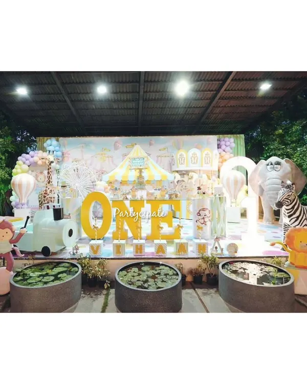 This pastel carnival party for Vihaan's first birthday was a dream to create. The main stage featured a large 'ONE' sign, a carousel, and friendly circus animal props, all in a soft, beautiful color palette.