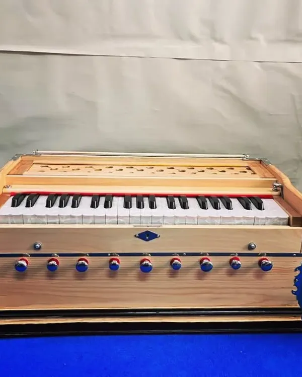 A front view of our new camel-colored harmonium. This model features a 3.5 saptak range, a coupler, and 9 stoppers, offering a rich bass-male sound suitable for kirtan and classical music.