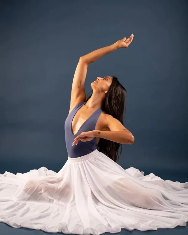 A graceful pose from the 'Swan Song' photoshoot. This series explores the elegance and lines of a dancer's body, blending portrait photography with the art of movement.
