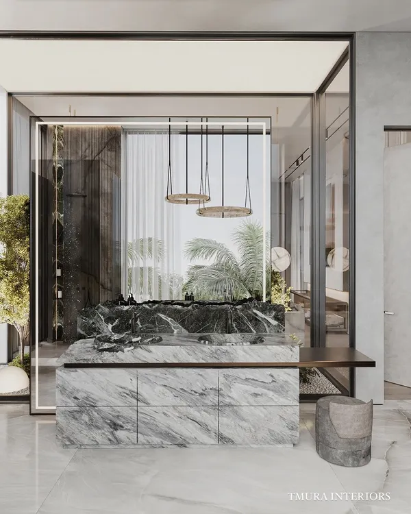 This custom vanity is a statement piece, crafted from a single block of heavily veined marble with a raw, unfinished top edge. The suspended pendant lights and minimalist stool complete this artistic and functional space.