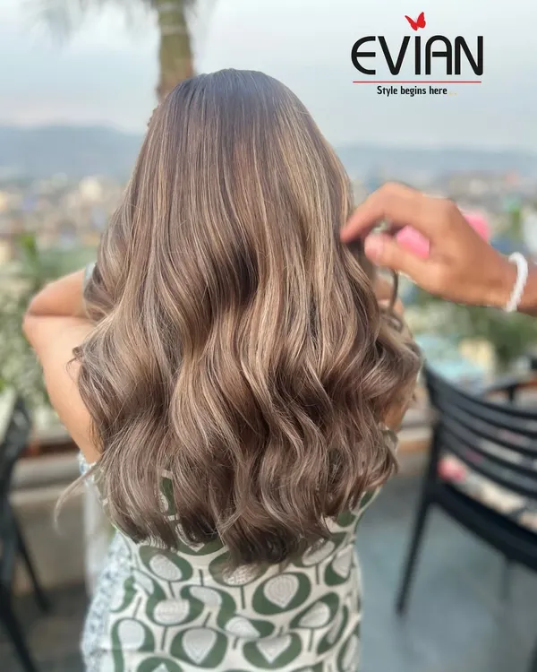 This beautiful ash-blonde balayage was created with a seamless blend of cool tones. The soft waves catch the light perfectly, showing off the different dimensions in the color.