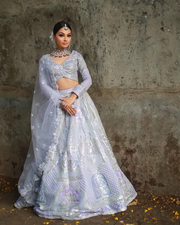This pastel lavender lehenga is a dream for any modern event. The full-length view shows the intricate silver embroidery and the lightweight fabric that allows for beautiful movement.