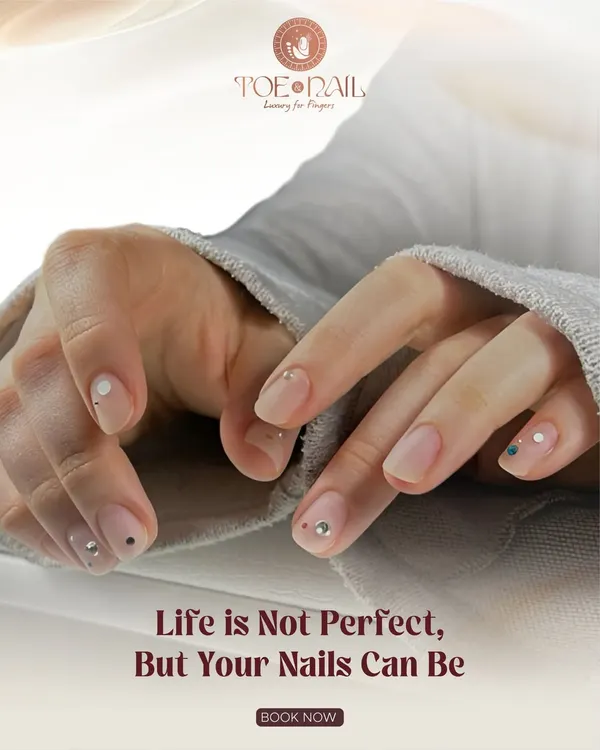 A subtle and elegant design featuring a natural-looking manicure with tiny, strategically placed rhinestones. This shows how a little bit of 3D sparkle can elevate a simple look.