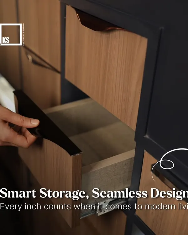 This image showcases our handleless drawer system, which uses a push-to-open mechanism for a seamless look. The combination of wood-grain drawers and a dark frame creates a modern, sophisticated storage unit where every detail is considered.