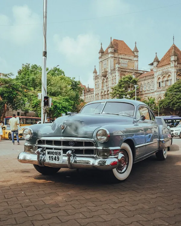Timeless charm cruising through Bombay streets. This vintage Cadillac from 1949 looks right at home in front of the city's historic buildings.