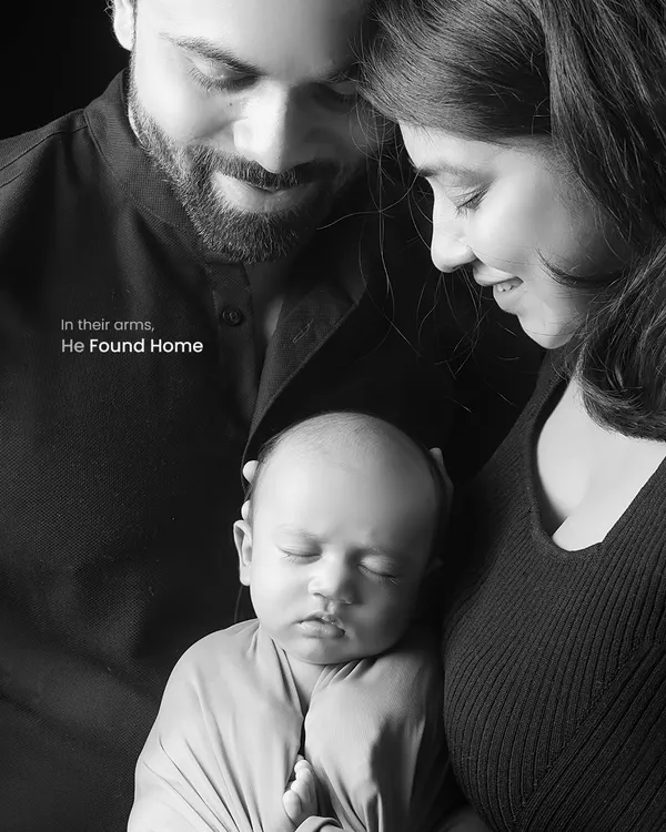 In black and white, the emotion becomes the focus. This intimate portrait captures the feeling of home, with parents gently holding their newborn, creating a powerful and timeless family heirloom.