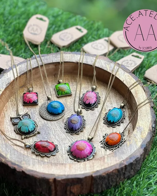 A beautiful collection of vintage-style floral pendants. Each one features a real dried flower preserved in resin, making every piece unique.