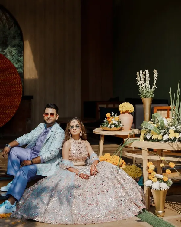 For Aashvi and Akash's Haldi Carnival, we coordinated his custom lavender kurta set with her pastel mirror-work lehenga for a look that was both playful and sophisticated.