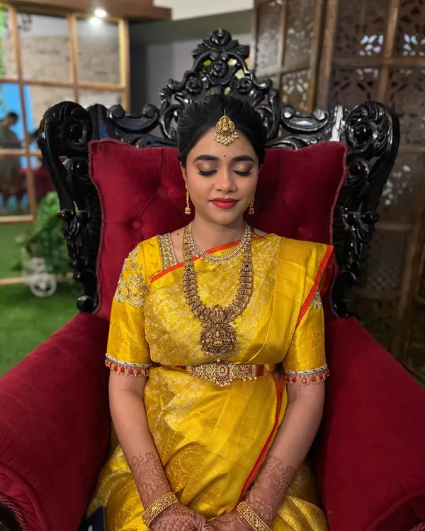 My beautiful bride glowing at her baby shower function. She wanted a classic look with bold red lips and is wearing a traditional temple jewellery set.