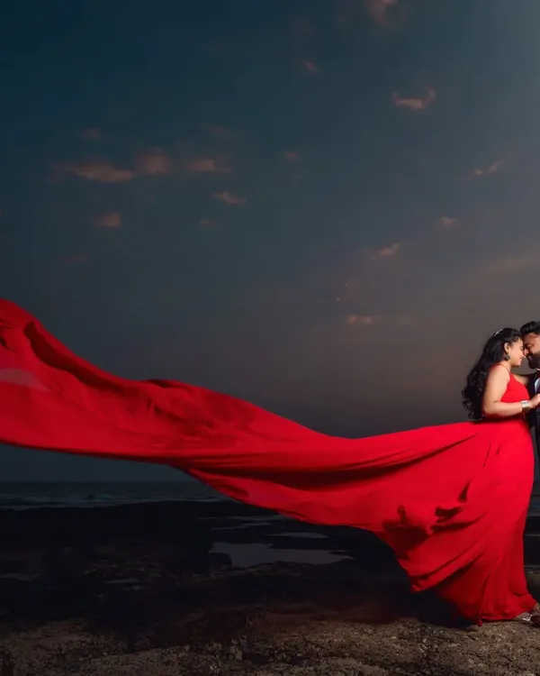 Create a picture-perfect moment with this red long-tail gown, ideal for a dramatic pre-wedding shoot against a sunset. This couple's combo is available to rent.