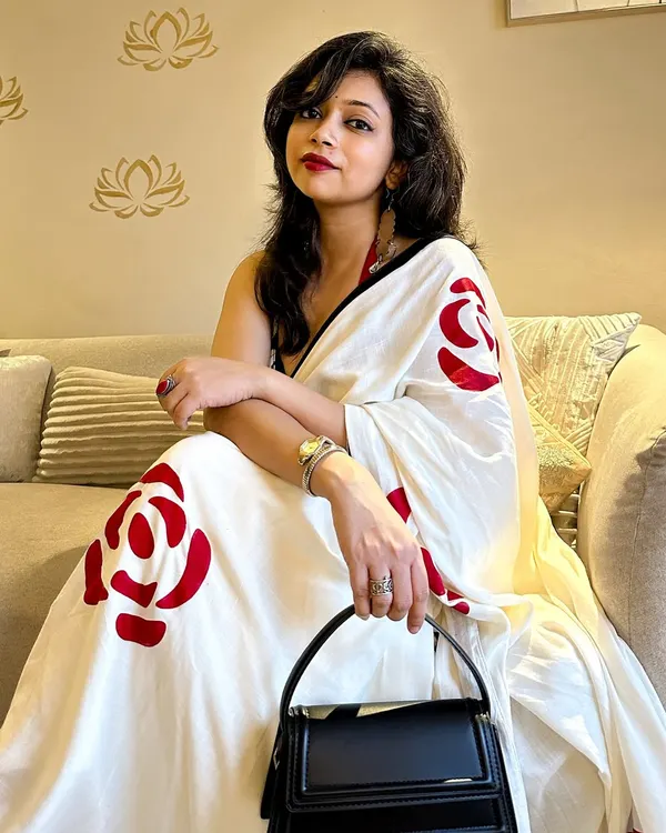 A saree date he'll never forget! This look is all about confidence, pairing a hand-painted saree with a bold red lip and a modern halter blouse for a chic and sultry vibe.