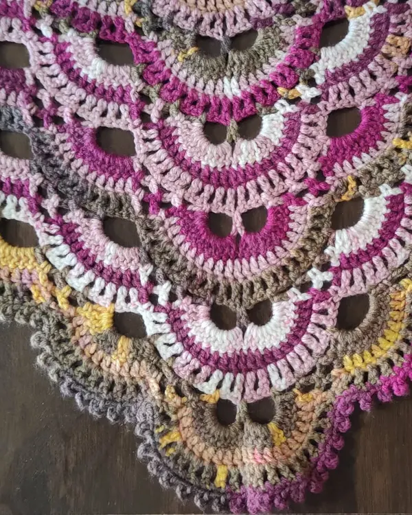 A close-up detail of the famous Virus Shawl pattern. You can see the repeating shell stitches that create the signature "viral" spread, which looks so beautiful with self-striping yarn.