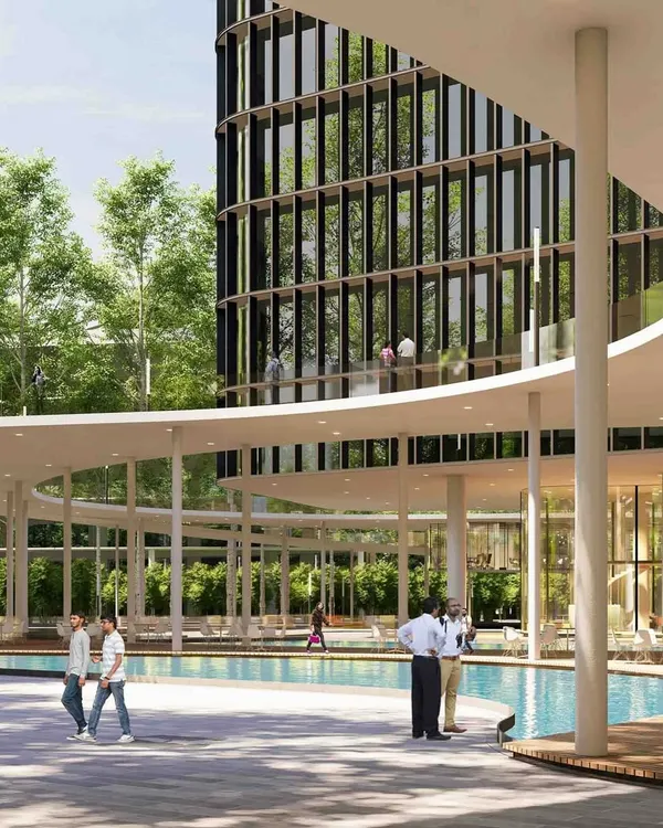 The ground level of this tech campus is designed as an inclusive community space. A large water feature and shaded walkways create a serene environment with restaurants and amenities, blurring the line between a private office campus and a public urban plaza.