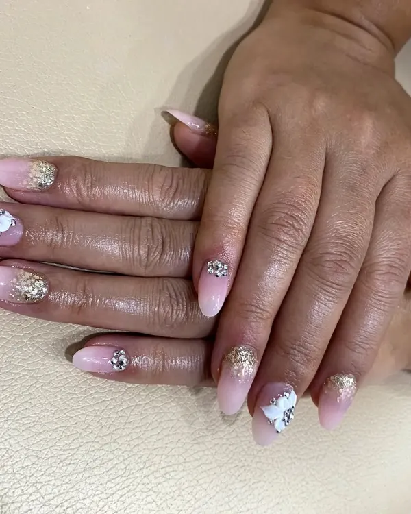 This photo shows a full set of nail extensions, demonstrating how I teach students to create both gel and acrylic nails. We compare the application process and final look of each in my classes.