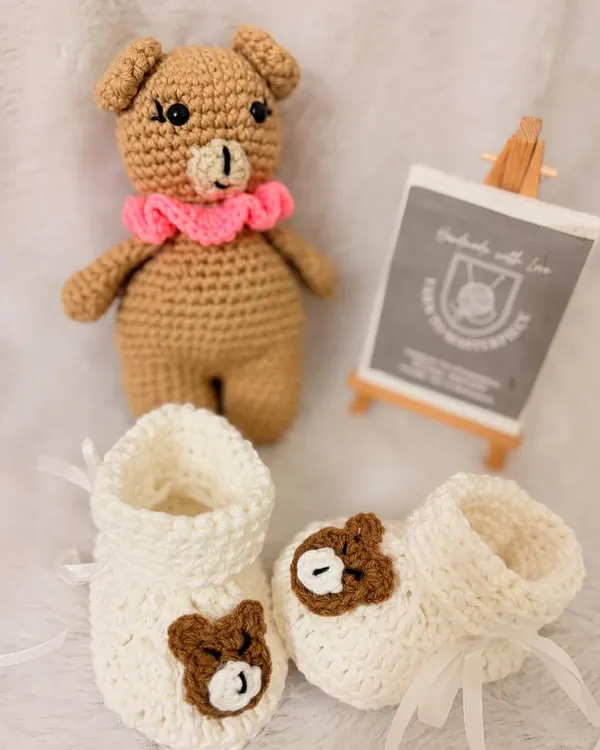This adorable combo set includes a 6-inch amigurumi bear and a matching pair of bear-themed booties, making it a perfect gift for a newborn.