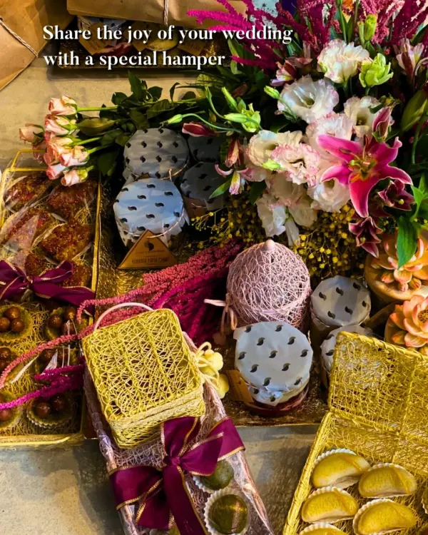 This bespoke wedding hamper is designed to capture the joy of your special day. It features a lush floral arrangement alongside an assortment of our signature sweets and savories, all packed in elegant, handcrafted boxes.