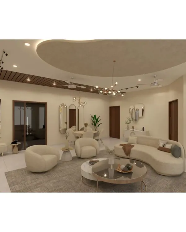 This living room design features soft, curved furniture in neutral tones, creating a gentle and inviting atmosphere. The organic shape of the false ceiling with cove lighting adds a unique architectural element to the space.