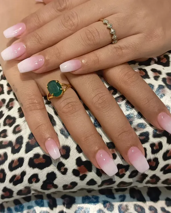 A close-up of our classic pink-to-white ombre nails on a squared coffin shape. The seamless blend and glossy top coat create a timeless and sophisticated manicure suitable for any setting.