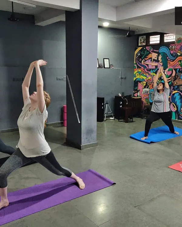 A typical group asana practice where we flow through poses like the Warrior pose. I focus on helping each student find their own expression of the posture while building strength and flexibility together as a class.