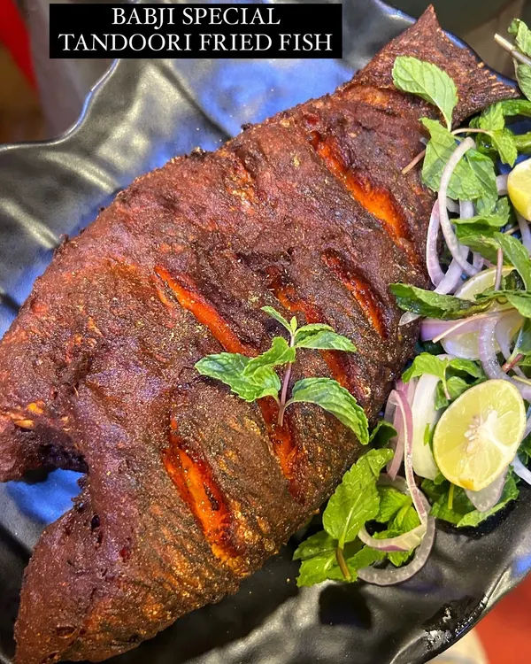 This is our signature Tandoori Fried Fish, a dish that has become a legend among our patrons. We use fresh, whole Tilapia, marinate it in our secret blend of tandoori spices, and fry it to crispy perfection. It's a must-try that keeps our guests coming back for more.