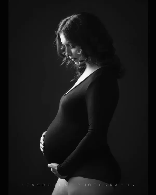 A classic black and white portrait that uses soft light to sculpt the beautiful curves of pregnancy. It's minimal, powerful, and timeless.