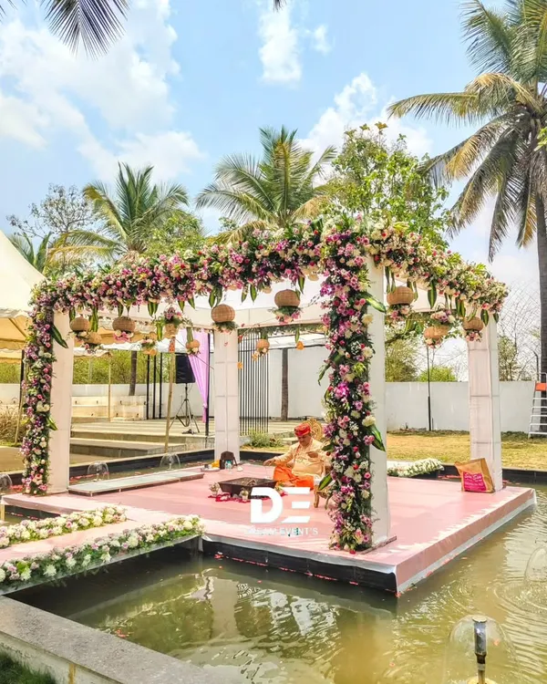 I designed this breathtaking floral mandap to sit over the water, creating a serene and unforgettable setting for the wedding ceremony. This is a perfect example of how I can transform a venue to create a truly one of a kind experience.