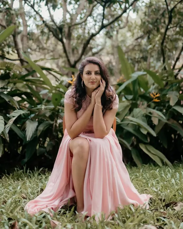 A quiet moment of reflection, captured during a photoshoot in a beautiful garden setting.
