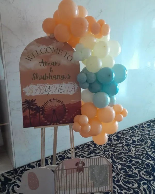 A personalized welcome sign for a "Babychella" themed baby shower. We use custom graphics and a trendy pastel balloon cluster to create a stylish and welcoming entrance for your guests.
