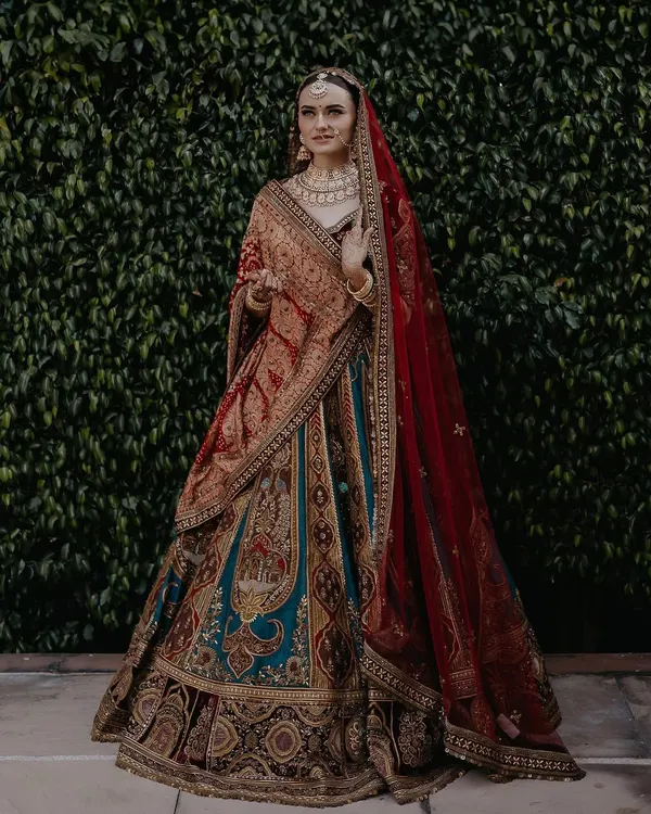 A full-length portrait showcasing Vraja's magnificent and unique bridal lehenga. I work with light and posture to create stunning images that highlight the intricate details of your attire.
