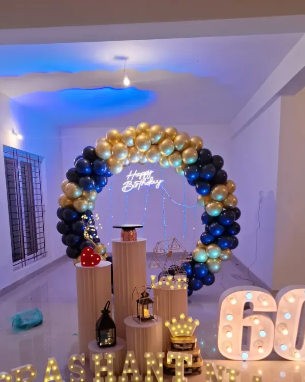 A grand celebration for a 60th birthday. I used a rich royal blue and chrome gold balloon ring, a neon sign, and large marquee numbers to create a truly memorable and elegant backdrop.